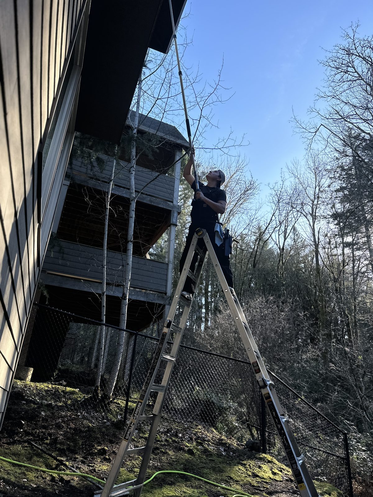 Leo, owner of Ace Exterior Cleaning, soft-washing a home in Vancouver, Washington